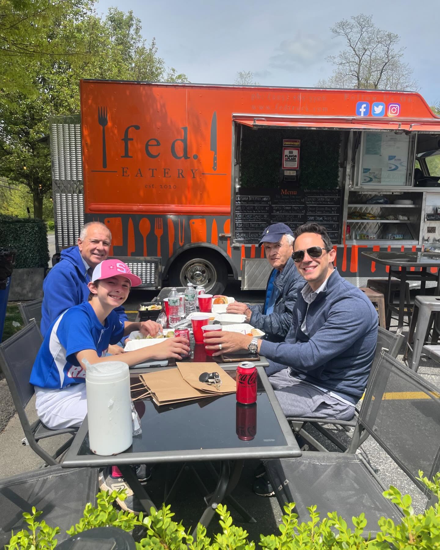 Customers enjoying a meal at Fed Eatery's outdoor patio seating